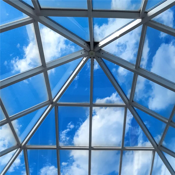 glass-roof-modern-office-building-against-blue-sky-with-clouds.jpg